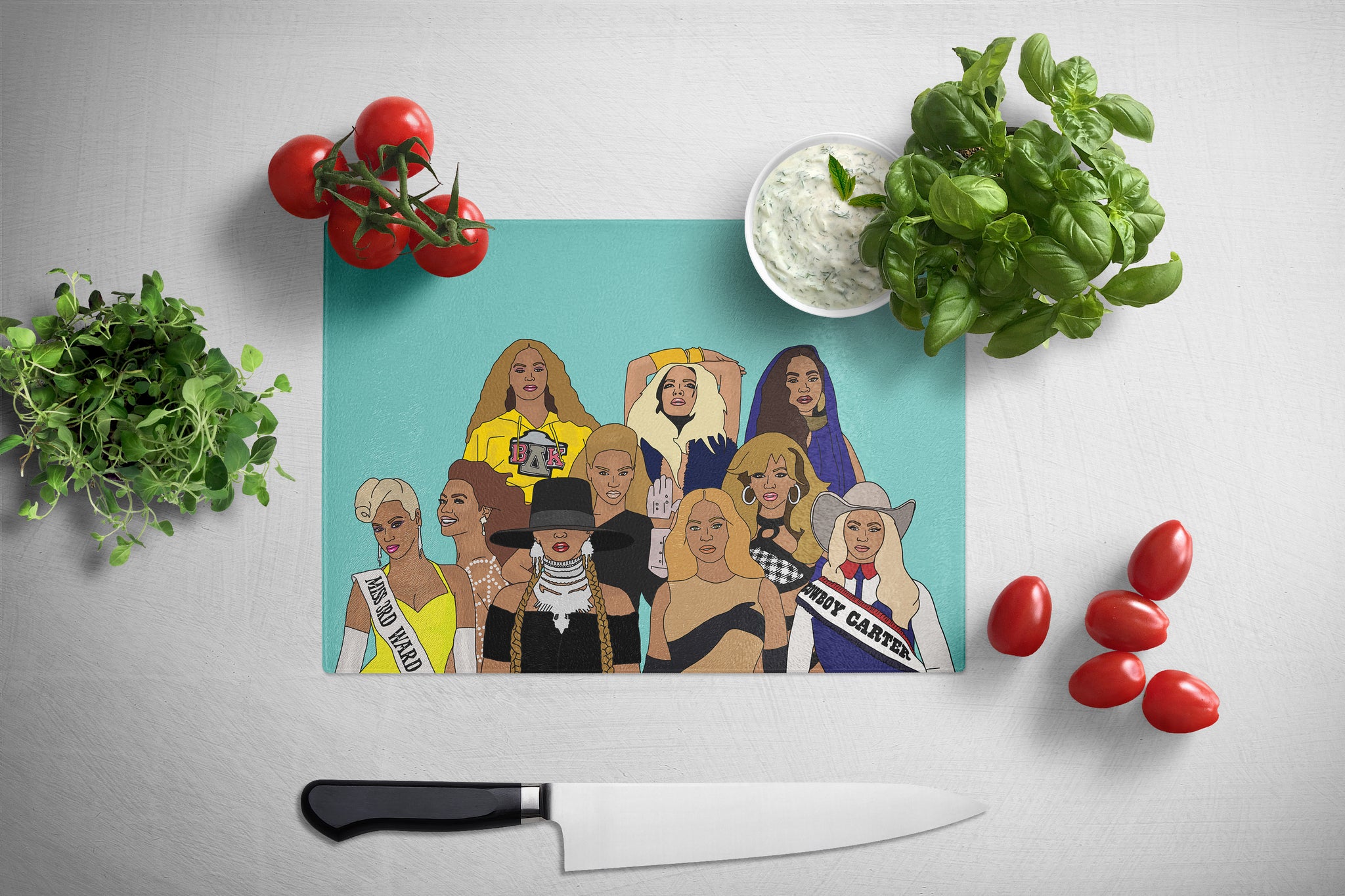 Cutting board with illustrated designs of Beyonce on a kitchen counter with vegetables and a knife.