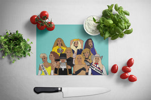 Cutting board with illustrated designs of Beyonce on a kitchen counter with vegetables and a knife.